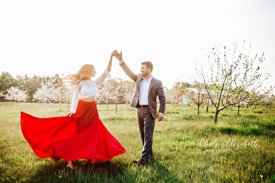 couple dancing in apple orchard