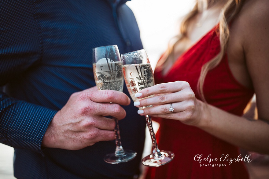 clinking glasses at engagement session