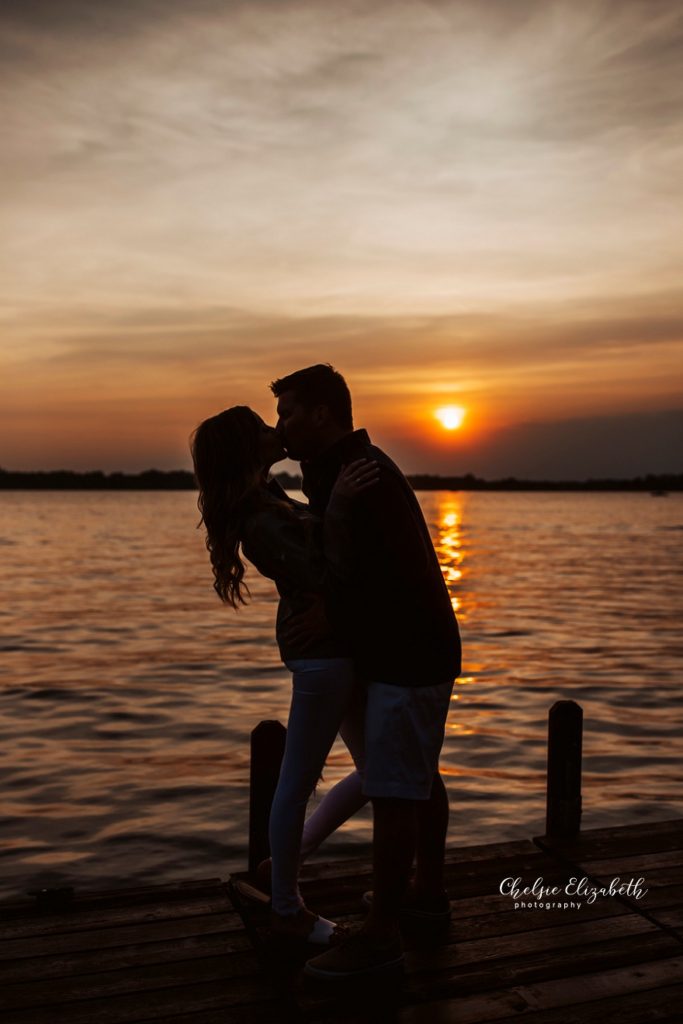 couple kissing at sunset