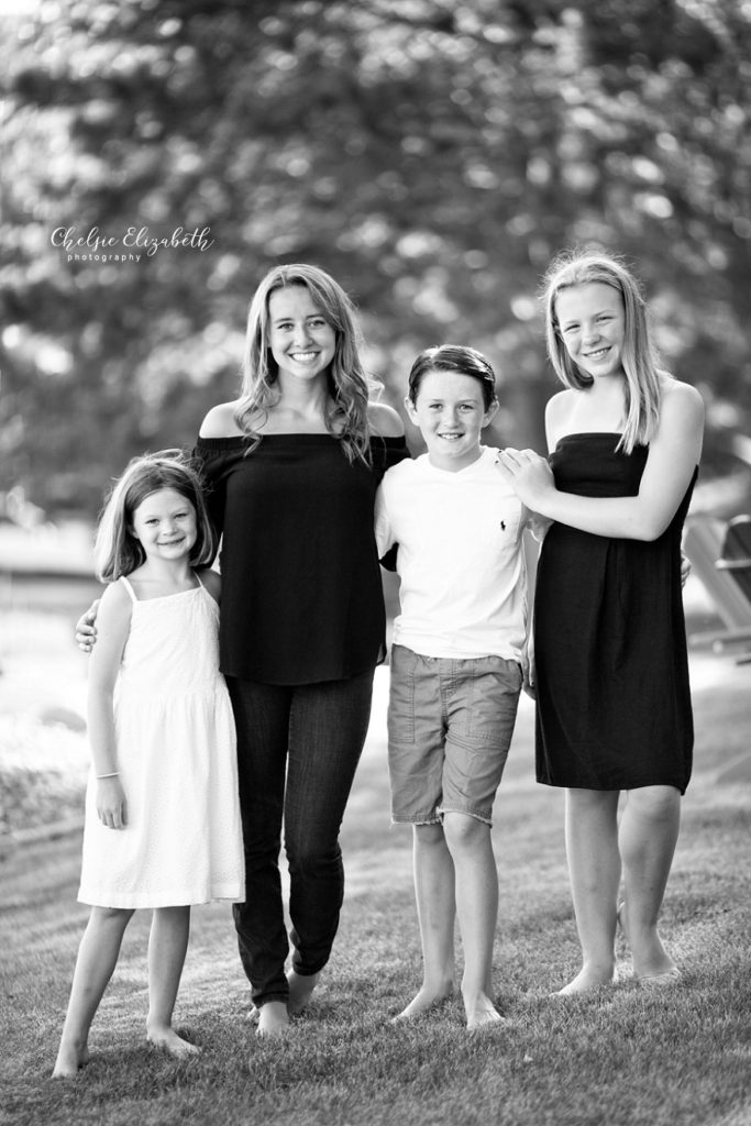 black and white image of 4 siblings