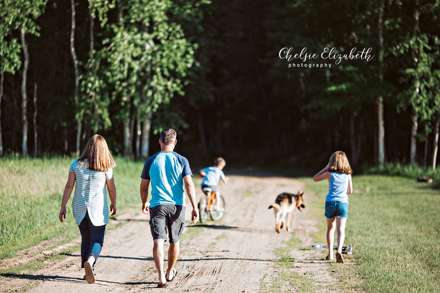 family walking on a gravel road in nisswa mn