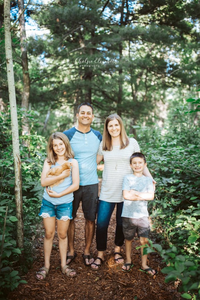 family of 4 in the woods