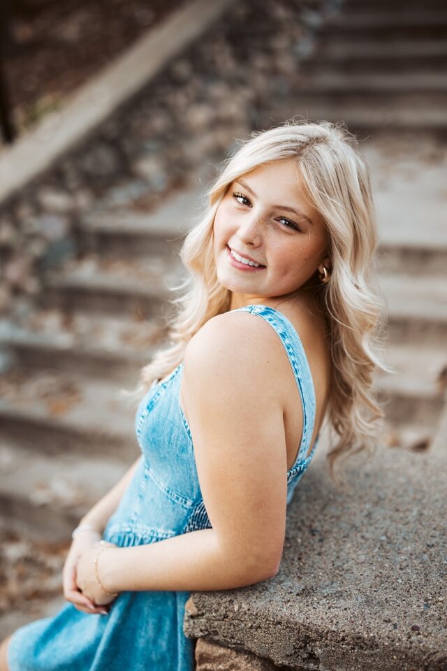 senior portraits at grand view lodge in nisswa mn.  female student on the stone stairs at Grand View Lodge