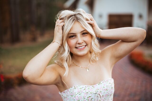 senior portrait session of a blonde girl in front at Grand View Lodge