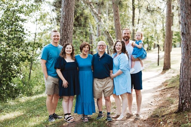 family standing together in wooded path at Boyd Lodge in Crosslake MN