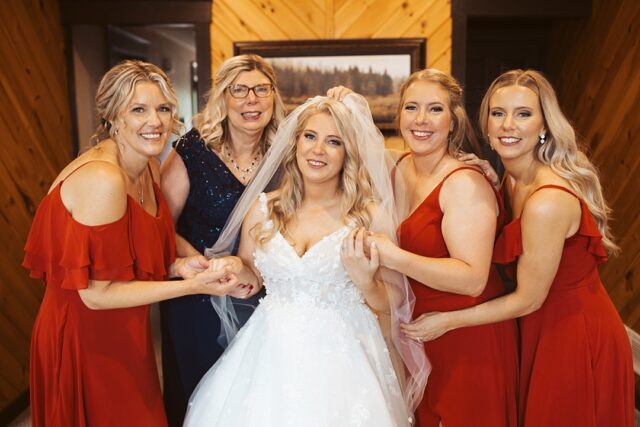 a bride and herbridesmaids getting ready to be married