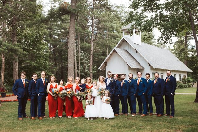 a large wedding party at Grand View Lodge.  Wearing orange dresses and blue suits at Grand View Lodge 