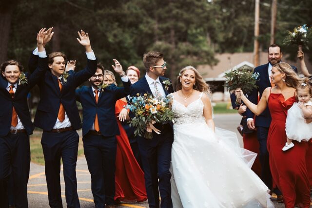 a happy bride and groom with their friends