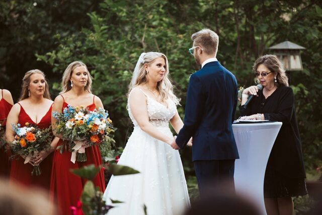 a bride looking at her groom during their outdoor wedding ceremony at Grand View Lodge in Nisswa MN