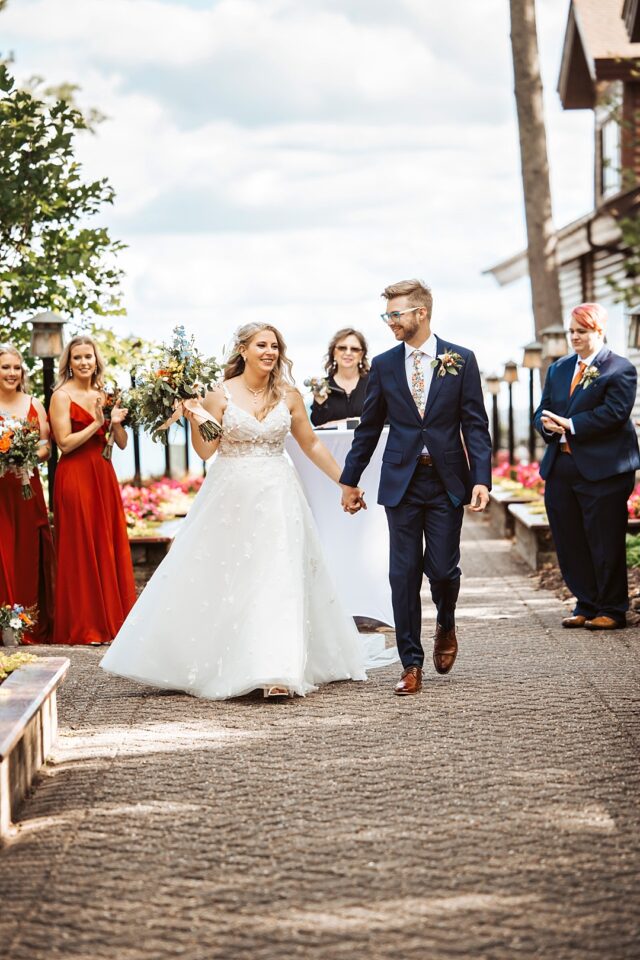 just married bride and groom walking up the aisle