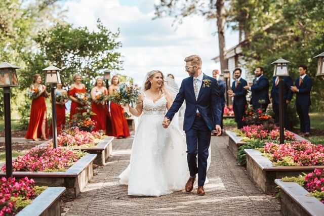 a happy bride and groom walking after being married in Nisswa MN