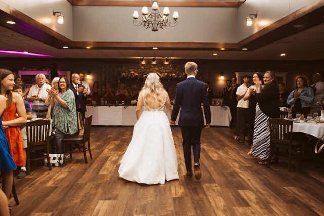 bride and groom entering their wedding reception in Heritage Room at Grand View Lodge