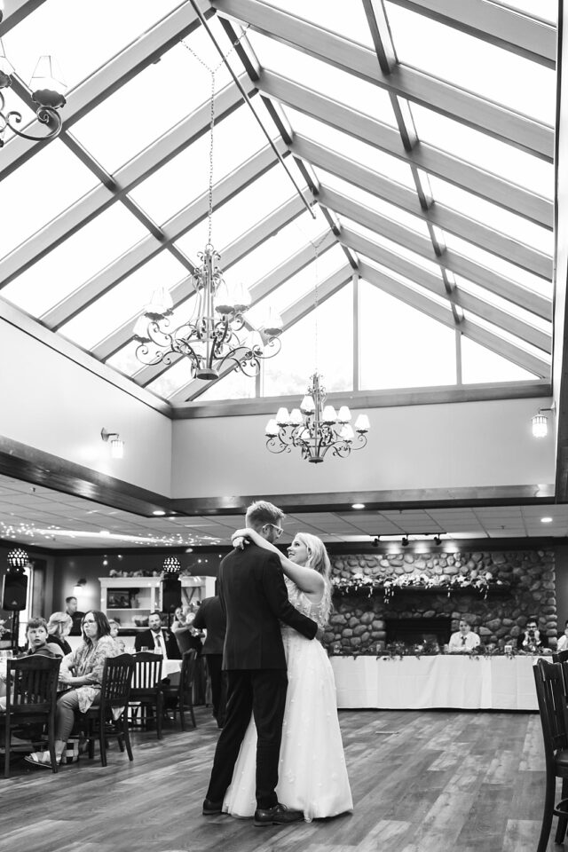 a black and white photo of a bride and groom shairng their first dance in Nisswa MN