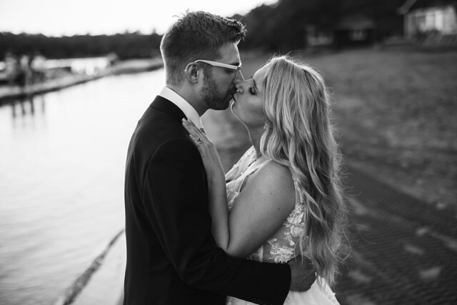 a romantic photo of a bride and groom on the beach in Nisswa MN